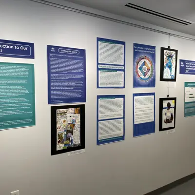 Research posters and infographics displayed on a gallery wall