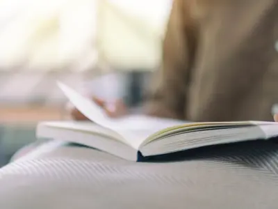 Closeup image of a woman opening and reading a book
